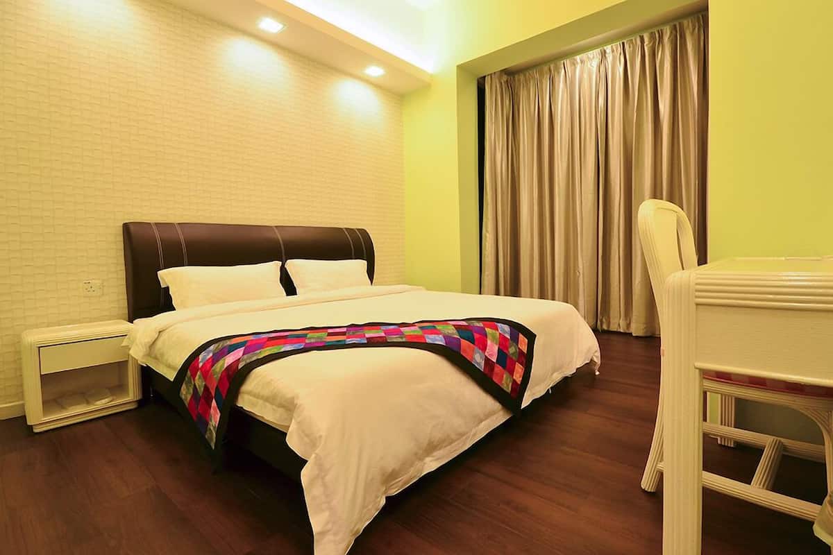A neatly arranged hotel room with a bed, a chair, and a nightstand.
