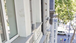 A hotel building with a balcony, a sign for Metro Hotel Apartments, and a street view with pedestrians. - Metro Hotel Apartments (Odesa)