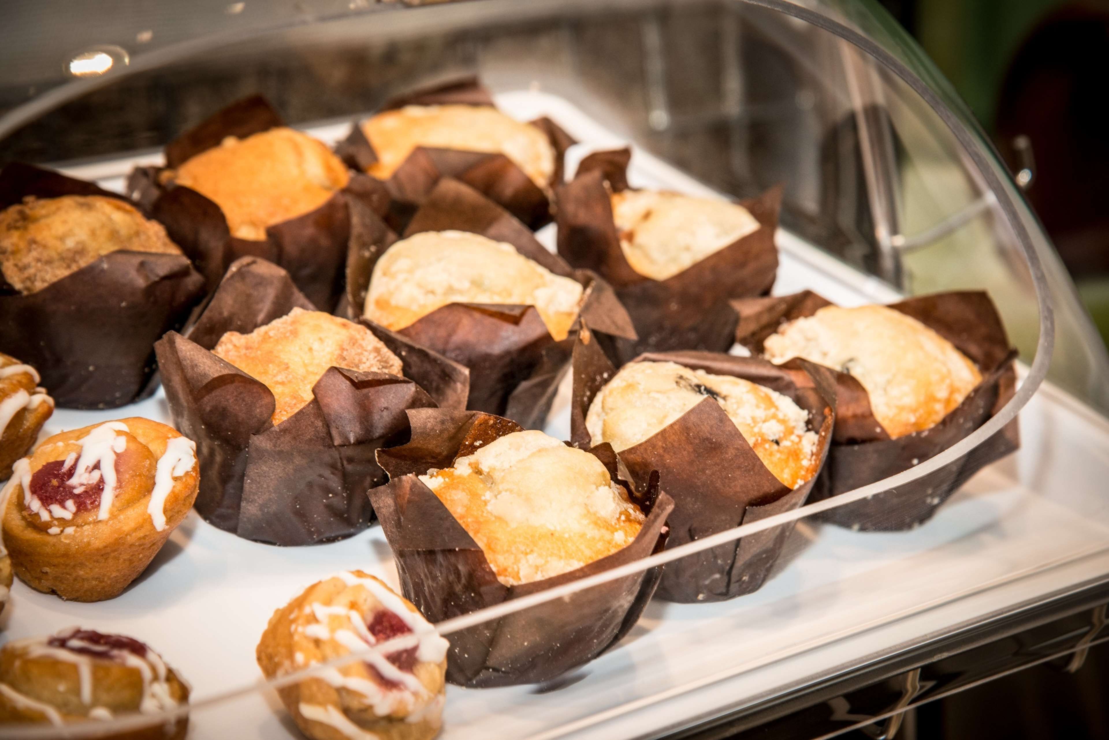 A display of assorted pastries in a bakery setting.
