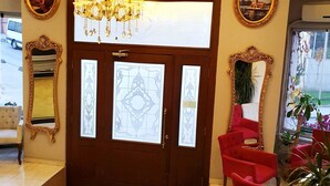 A hotel lobby with a grand chandelier, ornate mirrors, and red seating. - Sehir Hotel Old City (Istanbul)