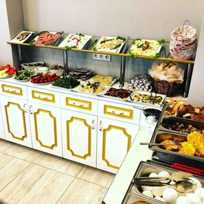 A buffet setup with various food items and utensils. - Sehir Hotel Old City (Istanbul)