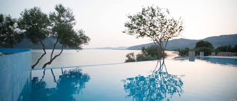 Indoor pool, seasonal outdoor pool, open 9 AM to 9 PM, pool umbrellas