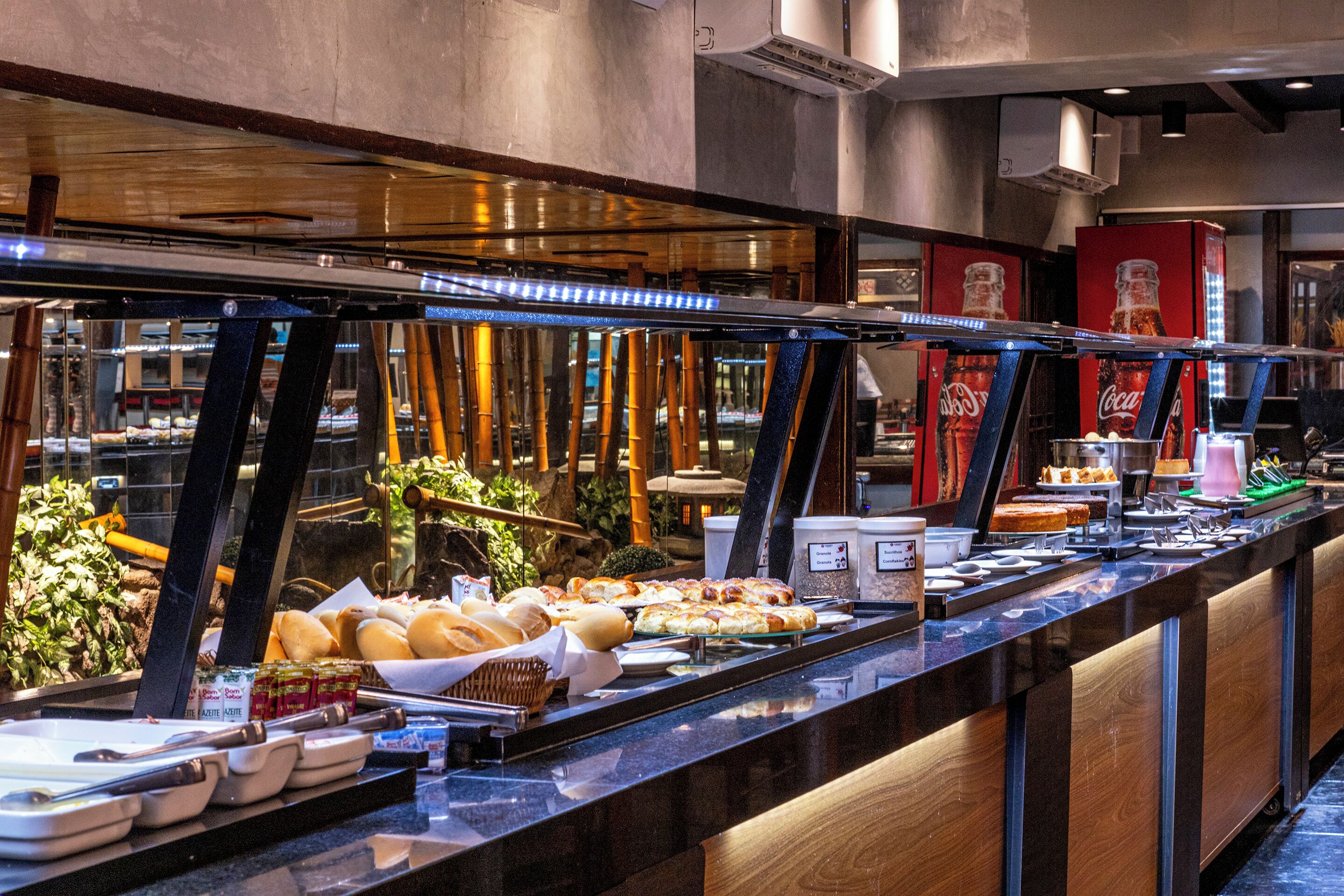 A buffet with various food items and a Coca-Cola display.