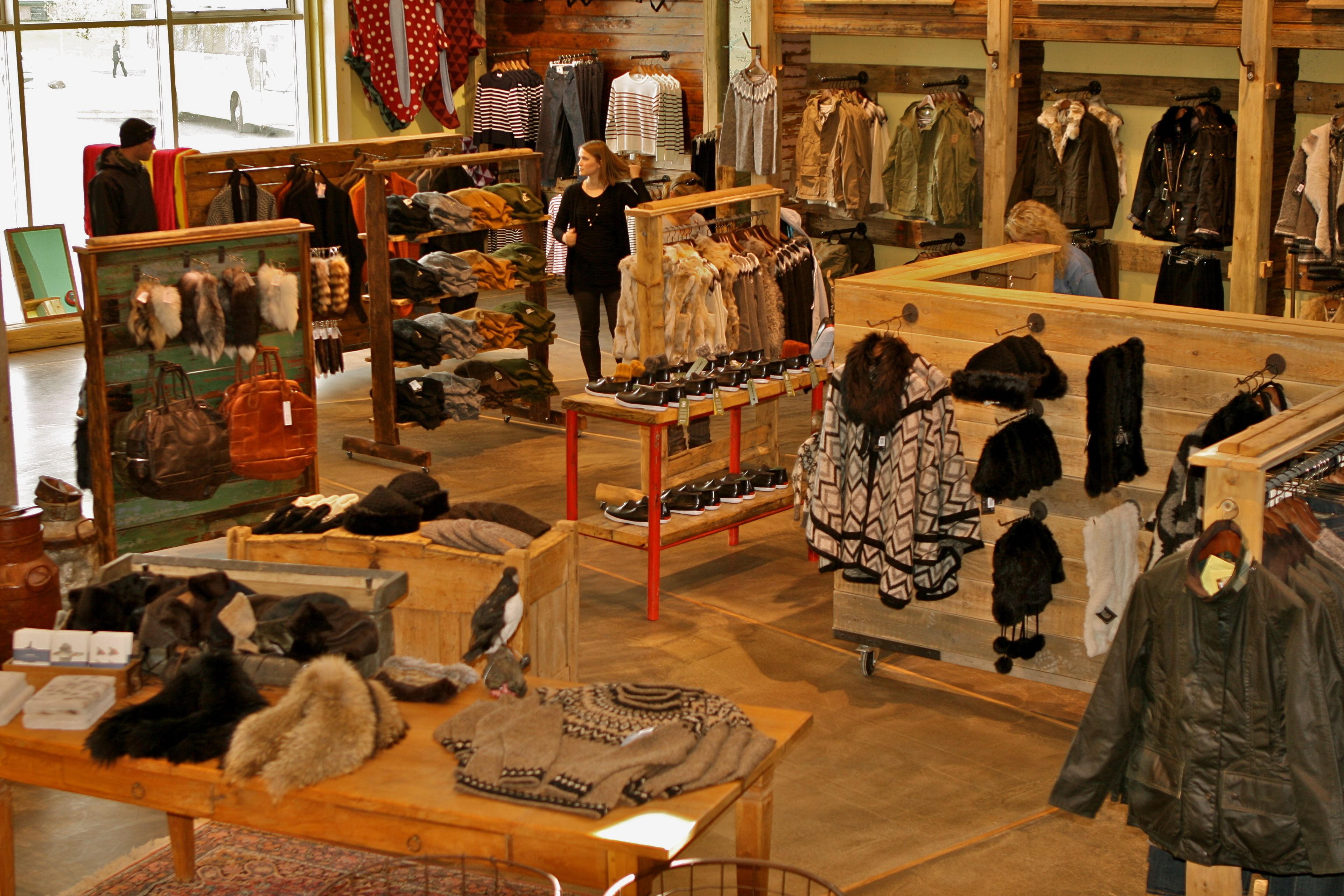 A clothing store with various garments and accessories on display.