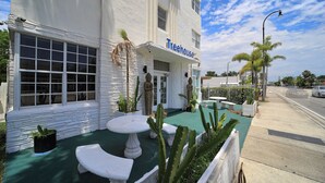 A building with a 'Treehouse' sign, outdoor seating, and cacti. - Treehouse  Hotel (Miami)