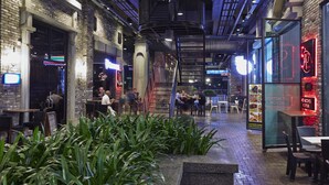 An indoor dining area with brick walls, modern lighting, and a central staircase. - Qliq Damansara (Petaling Jaya)