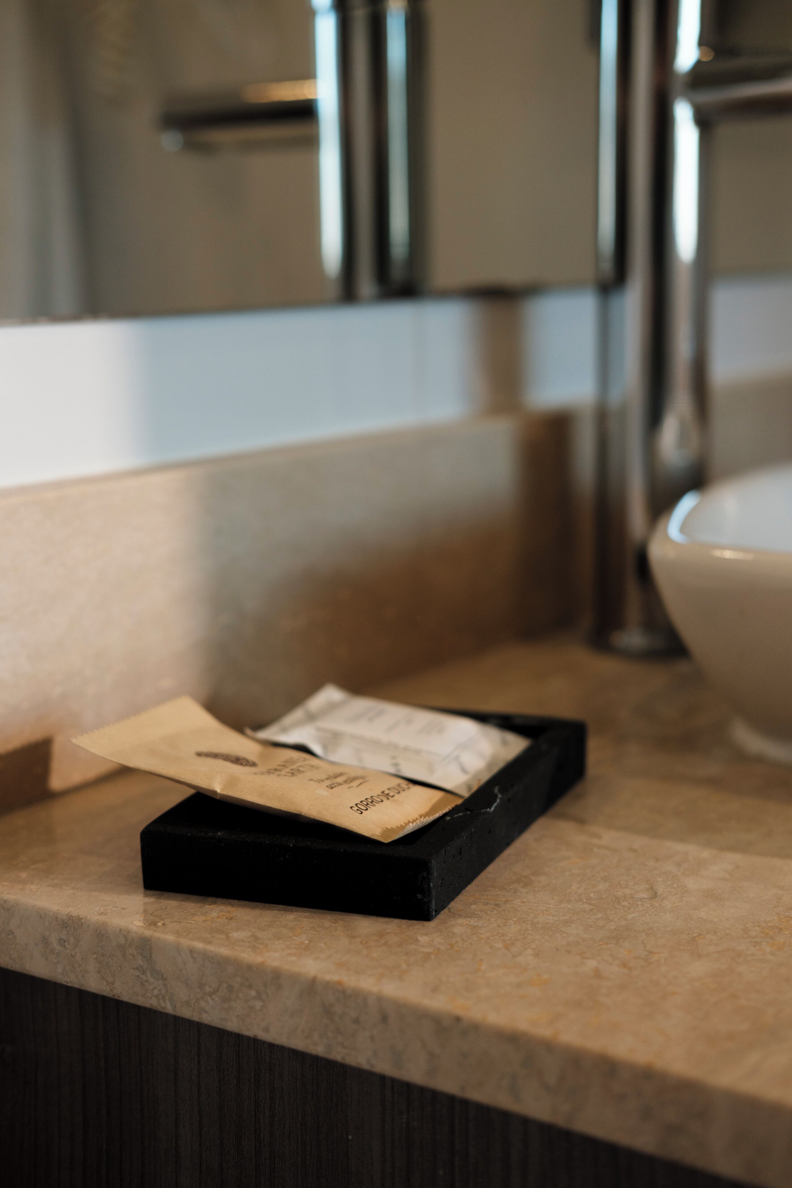 A kitchen counter with a black box containing a card and a small item.