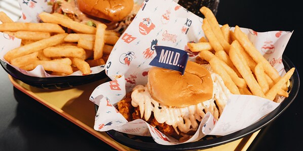 A tray with a chicken sandwich and French fries. - Hotel Nuve (Singapore)
