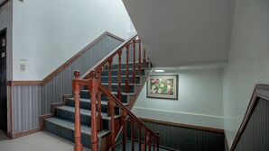 A staircase with wooden balusters and a handrail, leading to an upper floor. - OYO 700 Pj Inn Hotel (Angeles City)