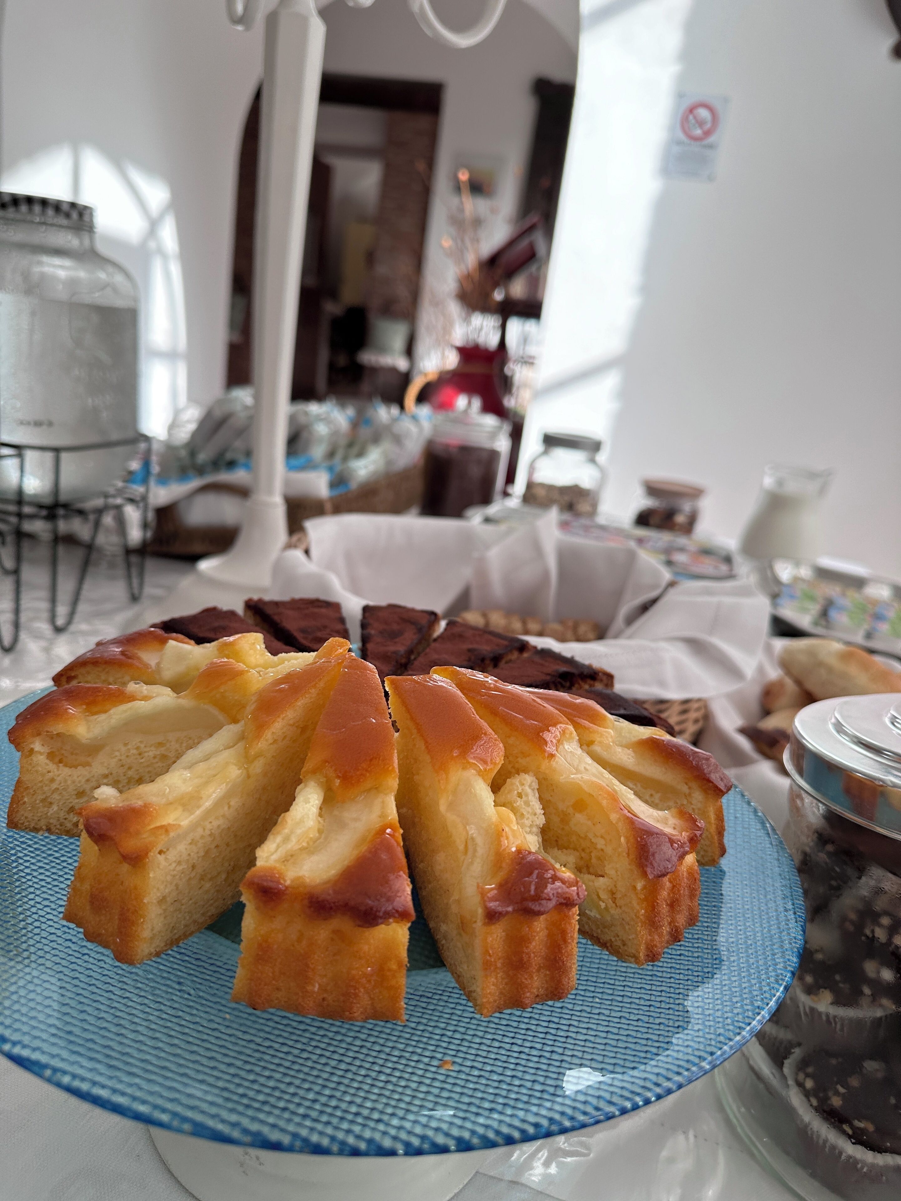 A table with a plate of bread and a jar of chocolate spread.