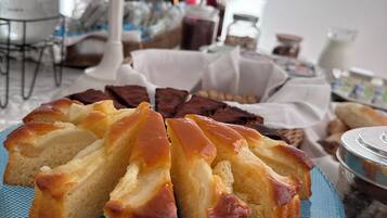 A table with a plate of bread and a jar of chocolate spread.