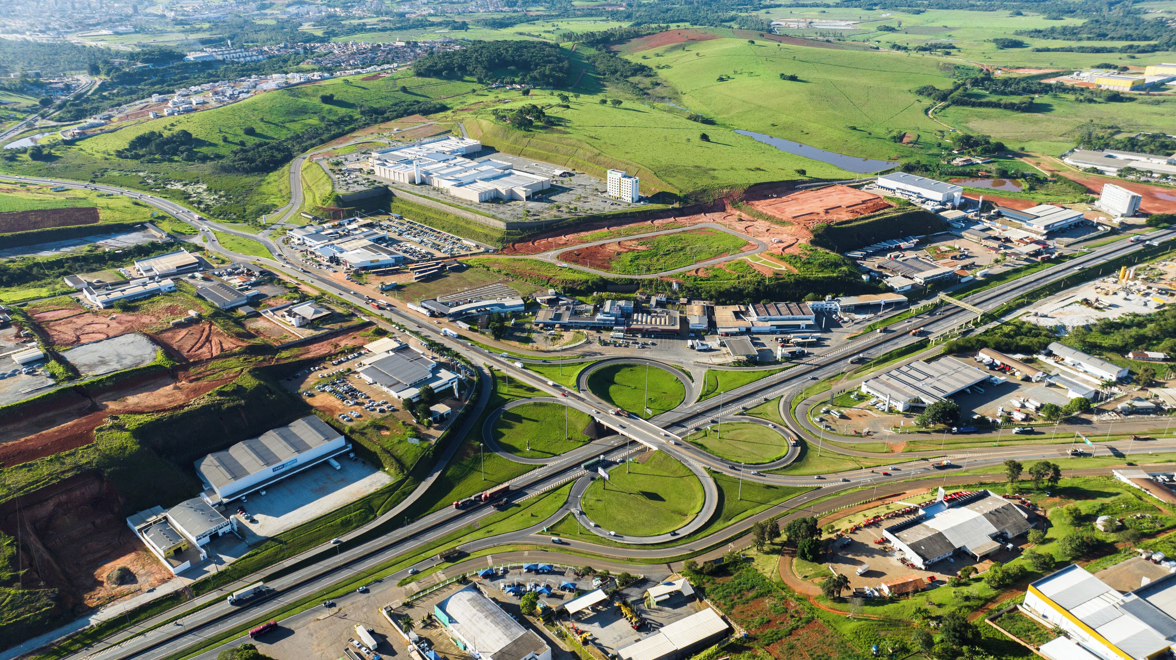 An industrial area with multiple buildings, roads, and a roundabout.