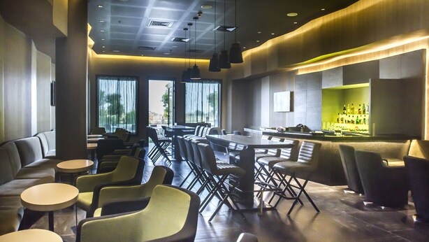A modern bar area with seating and a bar counter.