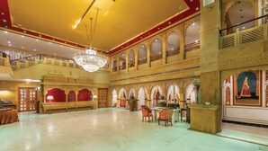 A spacious lobby with a chandelier, ornate arches, and a high ceiling. - Rang Mahal Jaisalmer (Jaisalmer)