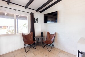 Premium Double Room | Living area | 19-inch flat-screen TV with cable channels, TV