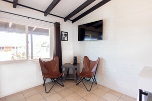 Premium Double Room | Living area | 19-inch flat-screen TV with cable channels, TV