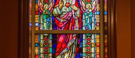 A stained glass window with religious figures and symbols.