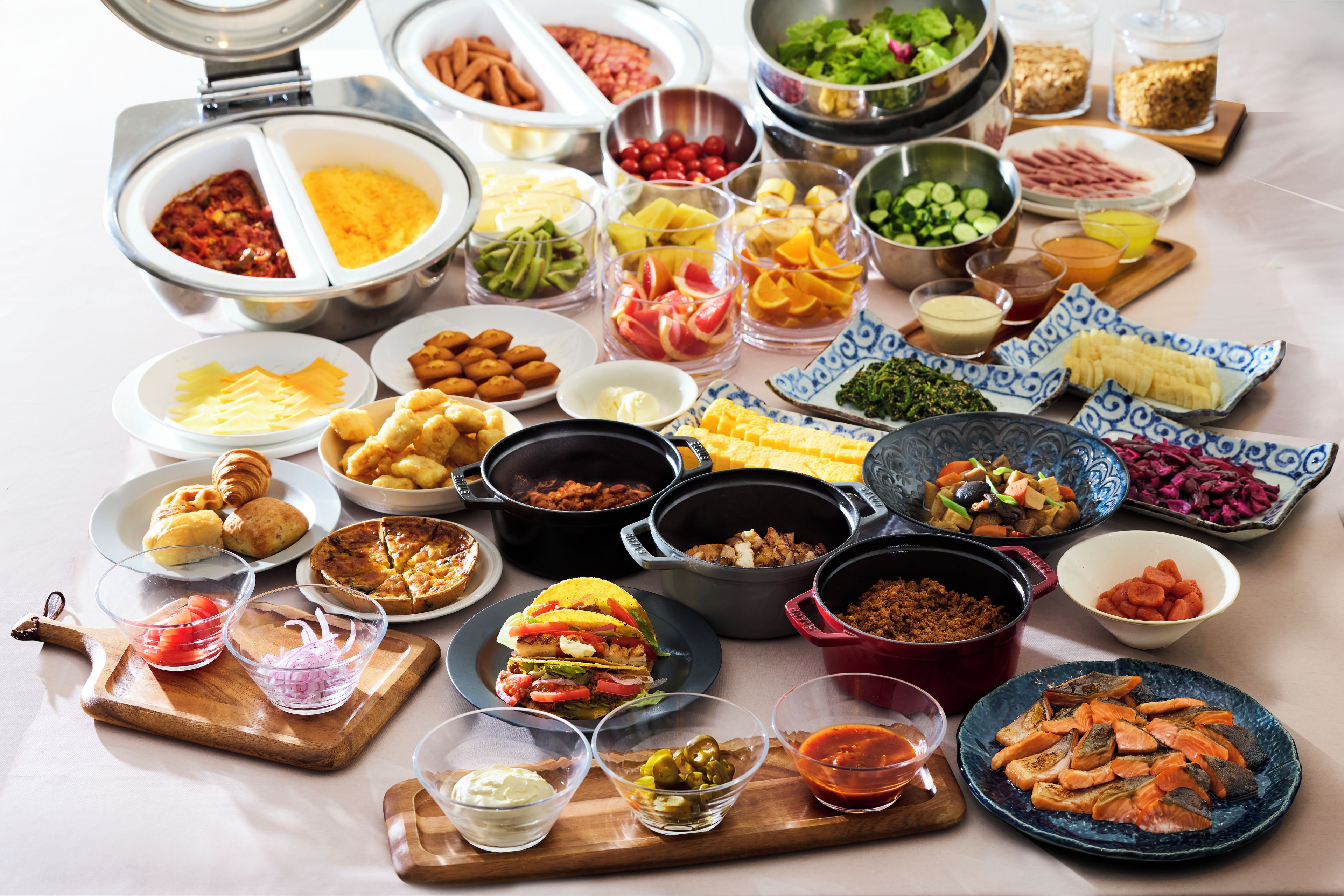 A buffet with various food items and dishes.