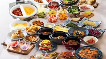 A buffet with various food items and dishes.