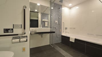 A modern bathroom with a toilet, sink, and bathtub.