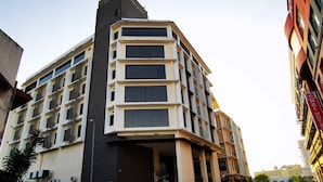 A multi-story hotel with a modern design, featuring a prominent entrance and a parking area in front. - La Boss Hotel (Malacca City)