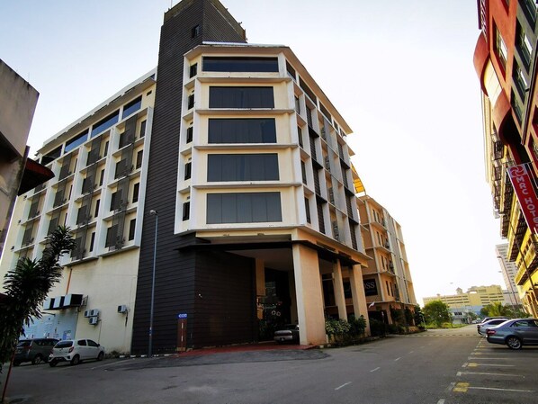 Stylish hotel building with a central entrance and large windows on each floor.