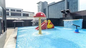 A rooftop pool with a water slide and a splash feature. - La Boss Hotel (Malacca City)