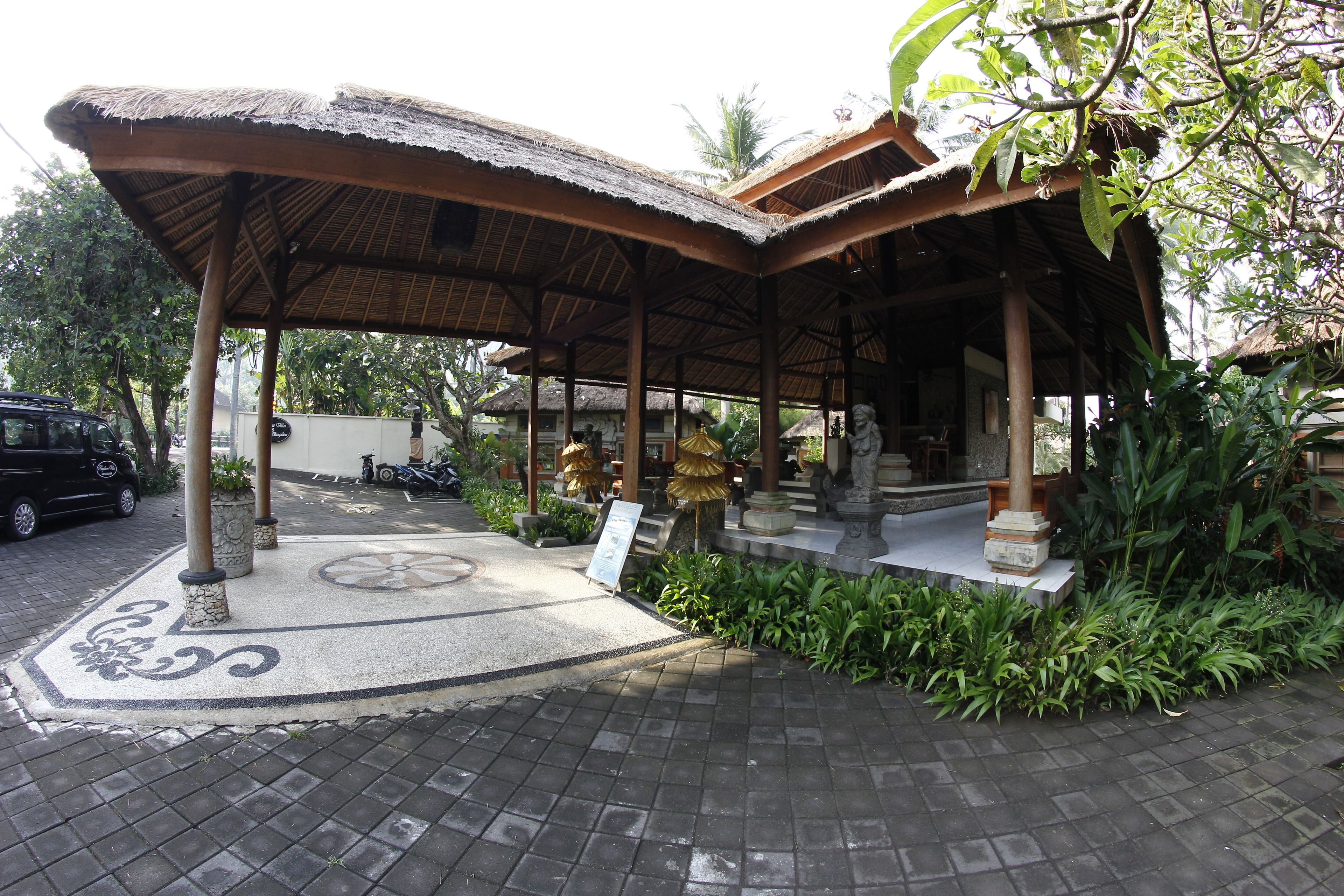 A covered outdoor area with a tiled floor and a decorative pattern.