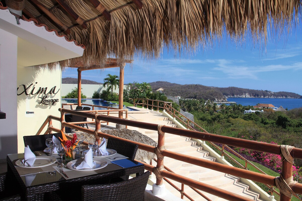 view of the pool and beach from the restaurant at Princess Mayev Huatulco Hotel