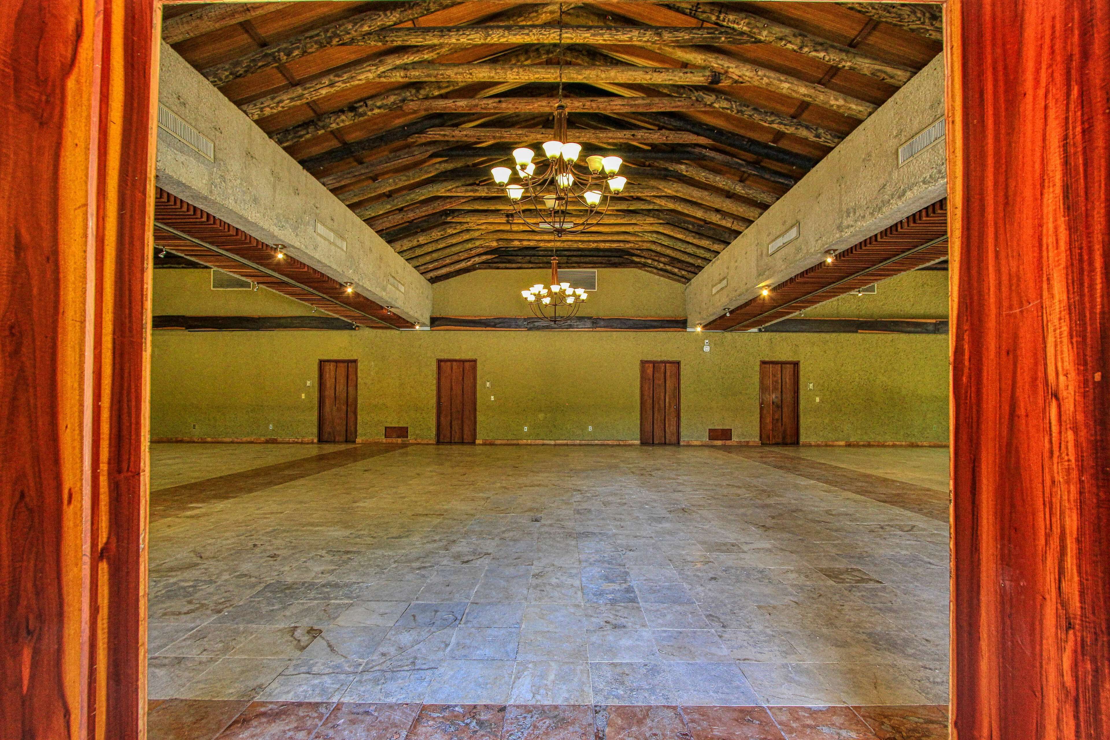 A spacious hall with a high ceiling and exposed wooden beams.