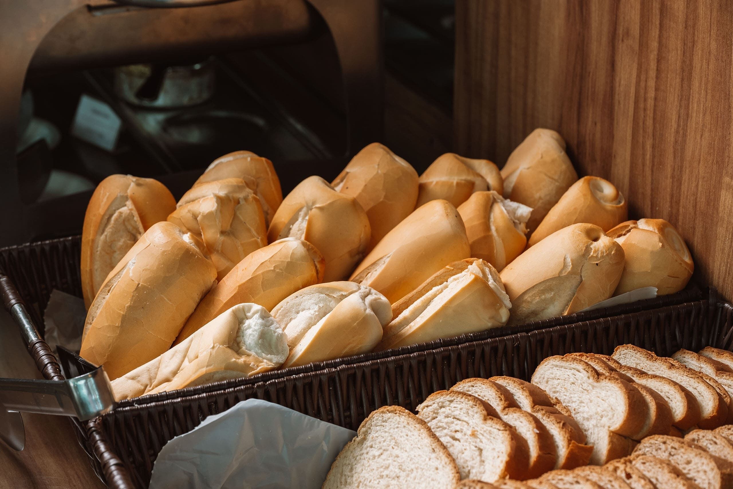 A basket of baguettes and sliced bread.