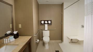 A modern bathroom with a toilet, sink, and shower area.