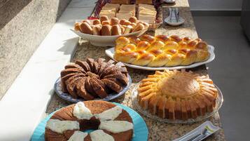 A buffet table with various baked goods and desserts.