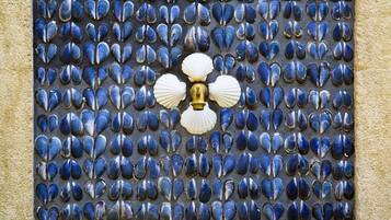 A decorative door with a pattern of blue and white shells.