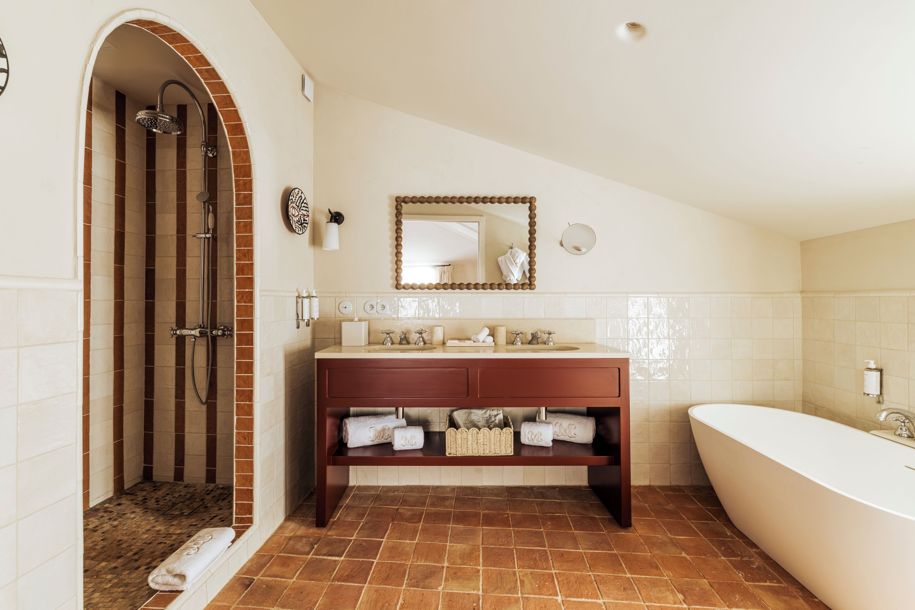 A bathroom with a shower, a sink with a mirror, and a bathtub.