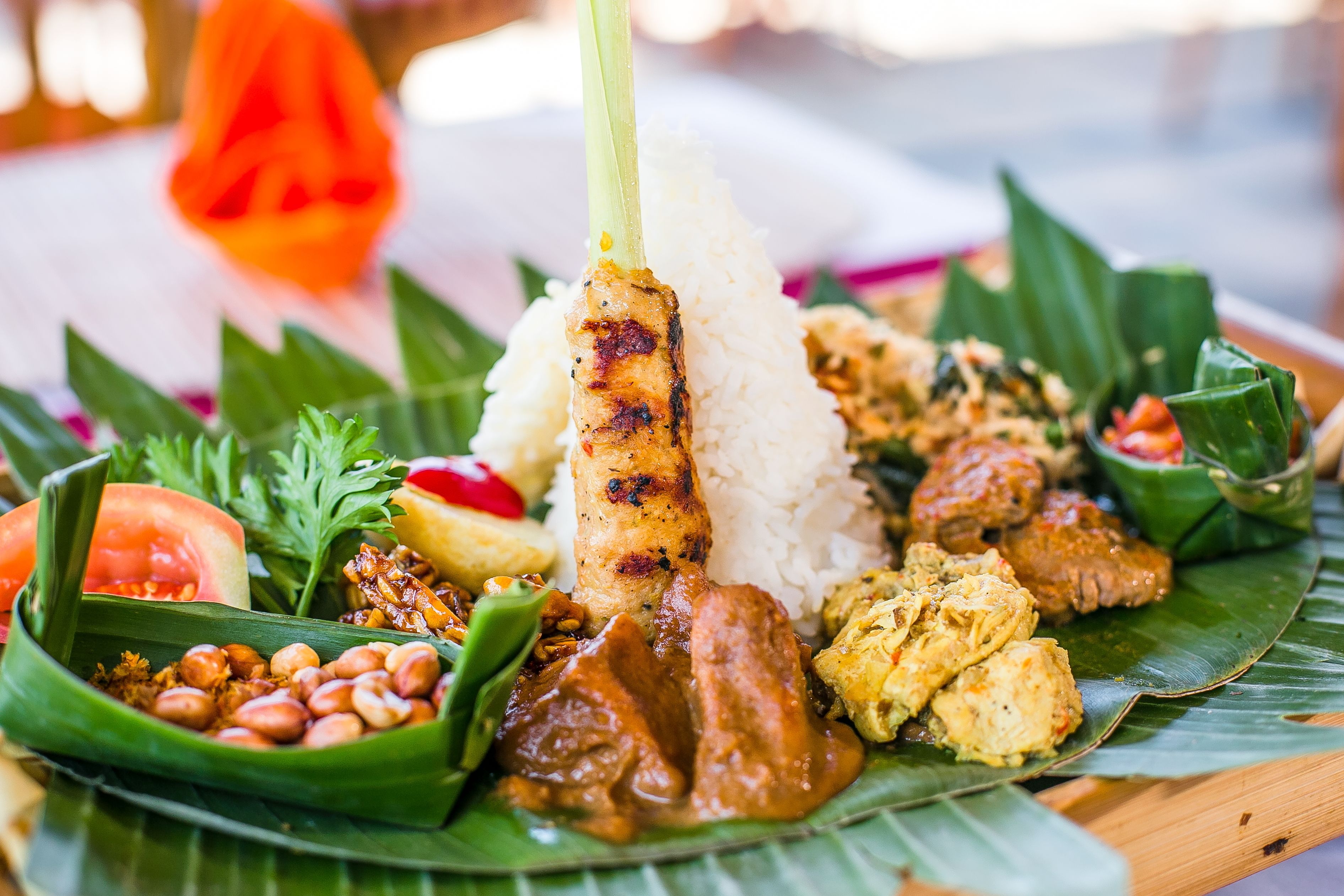 A plate of food with rice, grilled meat, and various side dishes.