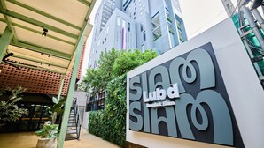 A modern building with a sign reading 'SLUB Bangkok.'