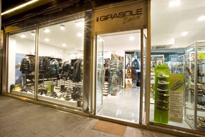 A shoe store with glass display windows and a sign reading "GIRASOLE". - Hotel Sayonara (Cattolica)