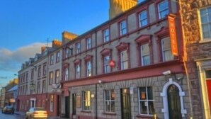 A historic hotel with a stone facade, multiple stories, and a red awning. - Charlemont Arms Hotel (Armagh)