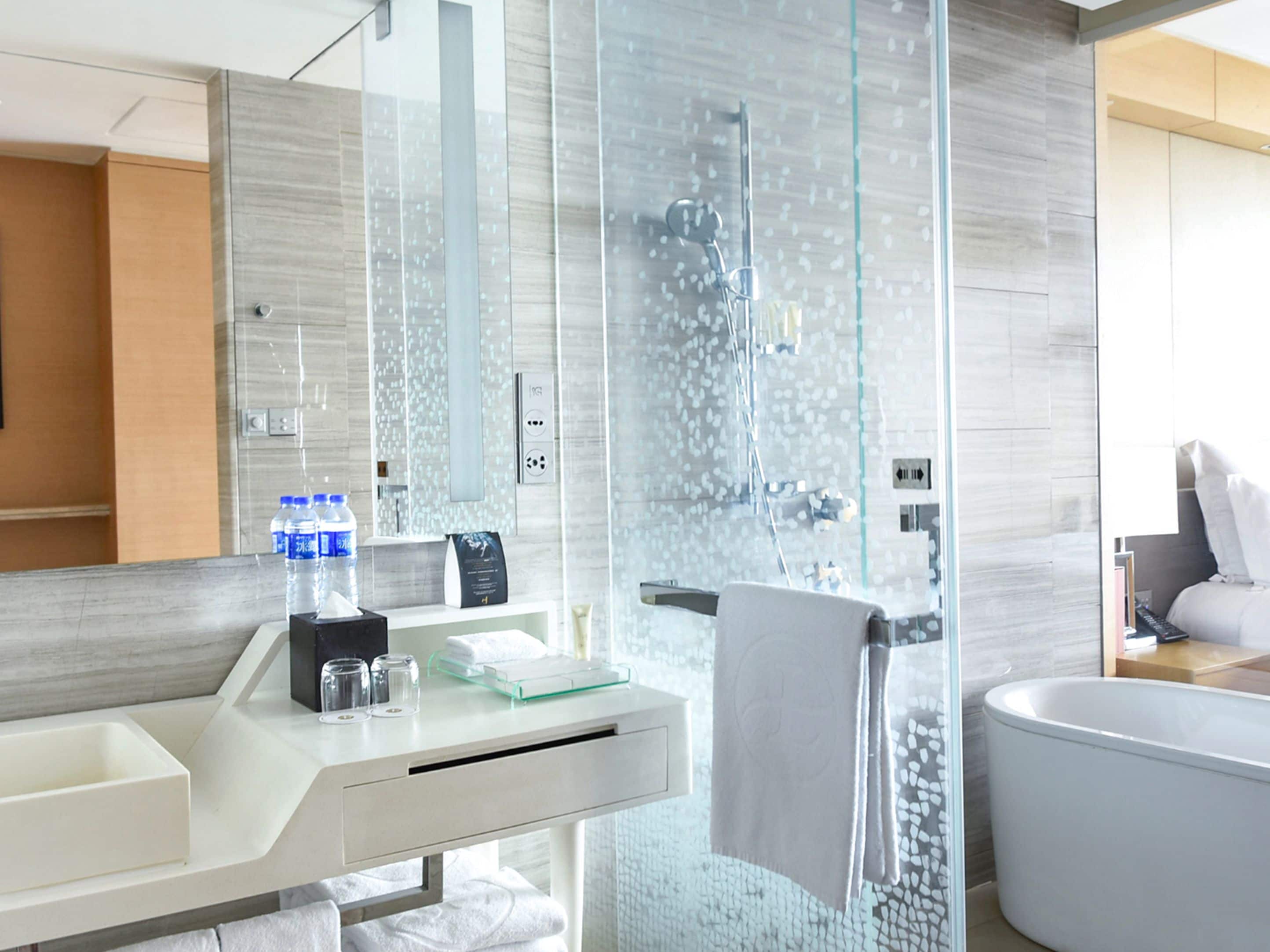 separate bathtub and shower, rainfall showerhead, designer toiletries