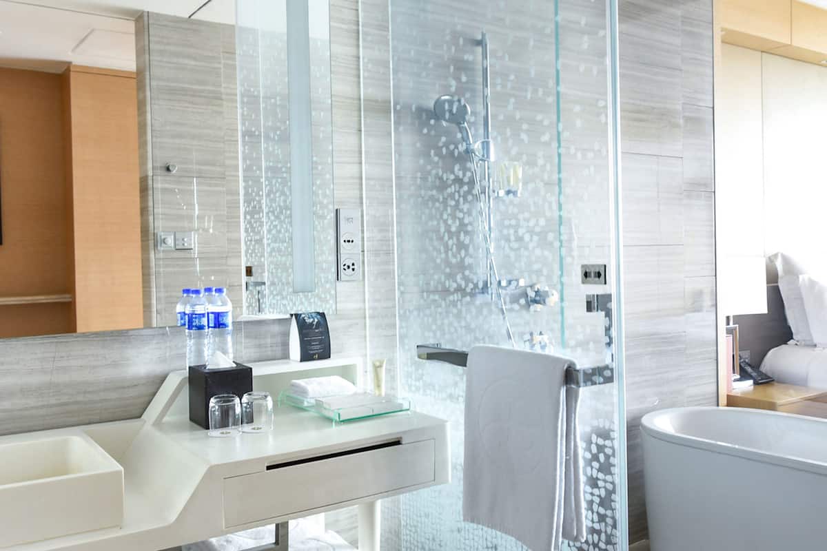 separate bathtub and shower, rainfall showerhead, designer toiletries