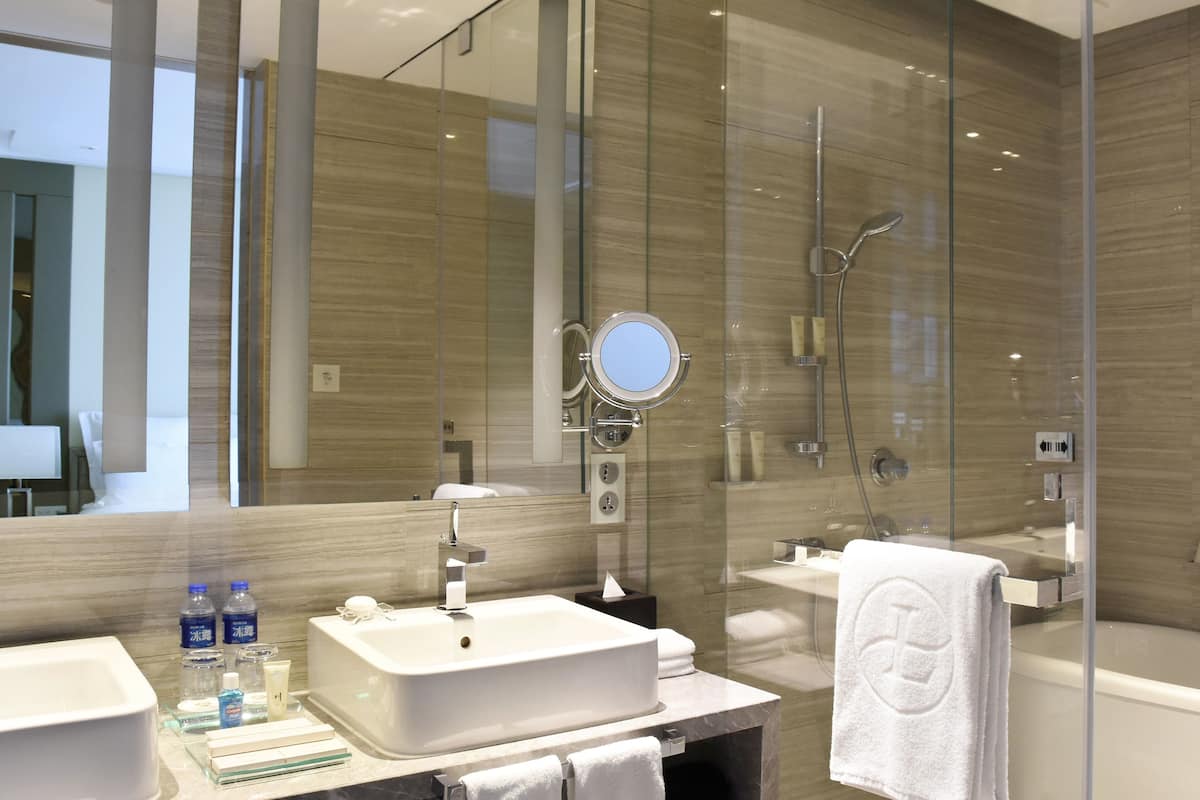 separate bathtub and shower, rainfall showerhead, designer toiletries