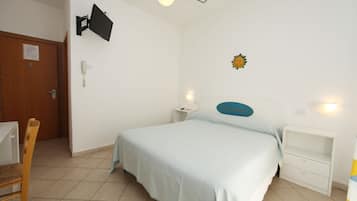 A bedroom with a bed, bedside tables, a desk, and a chair.