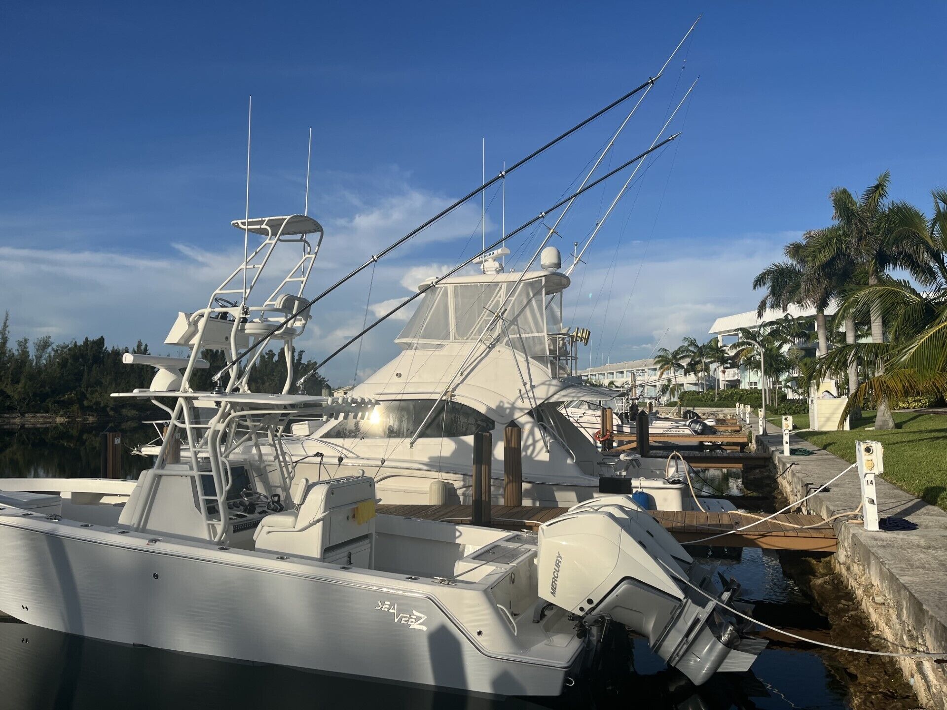 A marina with a large yacht docked, featuring a cabin, deck, and a visible winch.