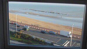 A view of a beach with a road and parked cars. - Lansdowne Hotel (Hastings)