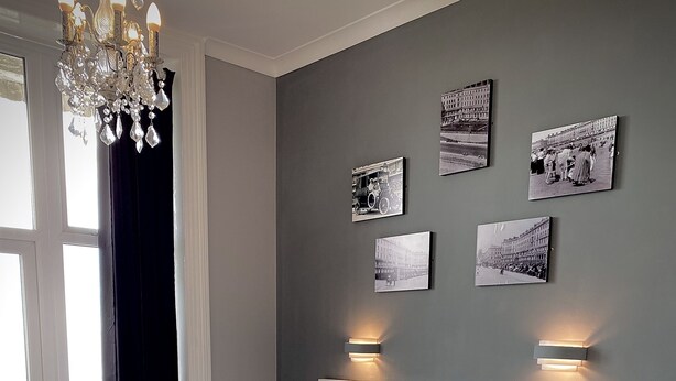 A neatly arranged bedroom with a large bed, bedside tables, and wall-mounted light fixtures. - Lansdowne Hotel (Hastings)