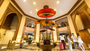 A lobby with a central decorative vase, wicker furniture, and a ceiling with recessed lighting. - Amazing Bagan Resort (Nyaung-U)