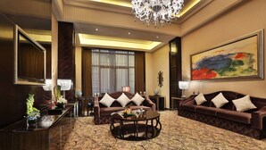 A hotel lobby with a large chandelier, a sofa set, a round coffee table, and a large abstract painting on the wall. - Howard Johnson Agile Plaza Chengdu (Chengdu)