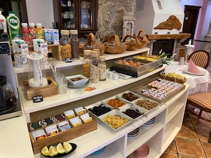 A buffet area with various food items, condiments, and beverages.