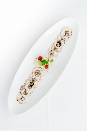 A white oval plate with a sushi dish.